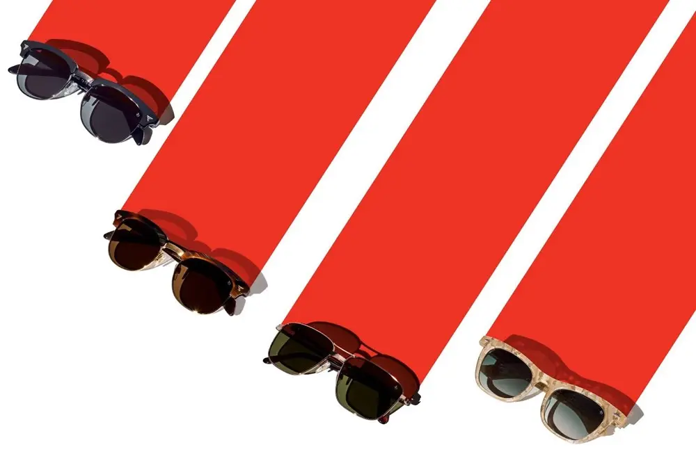 Sunglasses at the end of red stripes on a white background